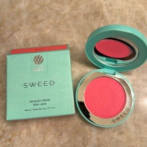 Sweed air blush cream in the color doll face which is a cool pink